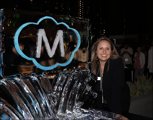 DeAnna Rogers posing with the Maropost ice sculpture at the Maropost Reception at Content & Commerce Summit 2017